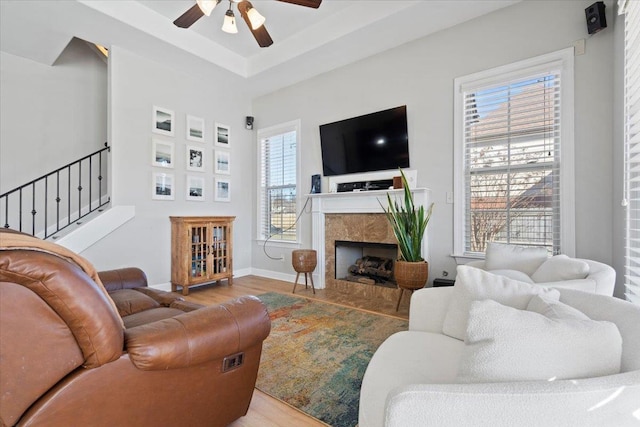 living room featuring wood-type flooring and ceiling fan