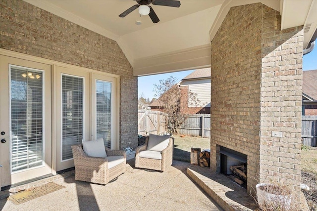 view of patio featuring ceiling fan and an outdoor brick fireplace