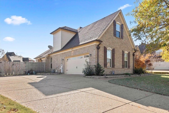 view of property exterior with a lawn and a garage