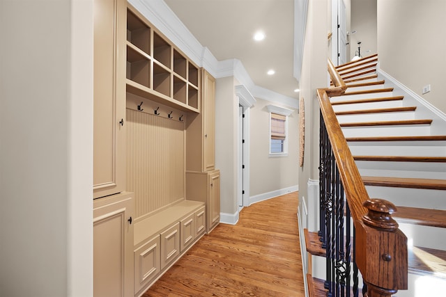 mudroom with crown molding and light wood-type flooring