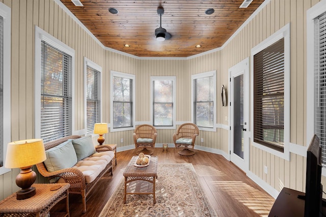 sunroom with ceiling fan and wooden ceiling