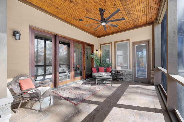 sunroom / solarium with ceiling fan and wooden ceiling