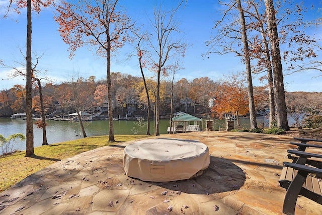 view of patio featuring a gazebo and a water view