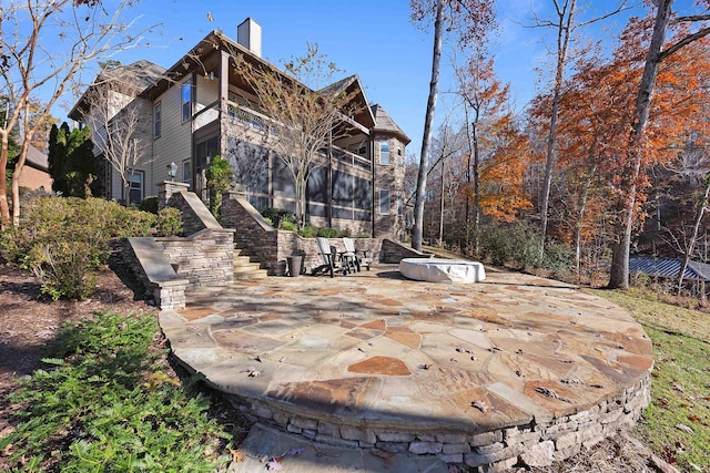 rear view of house featuring a balcony and a patio