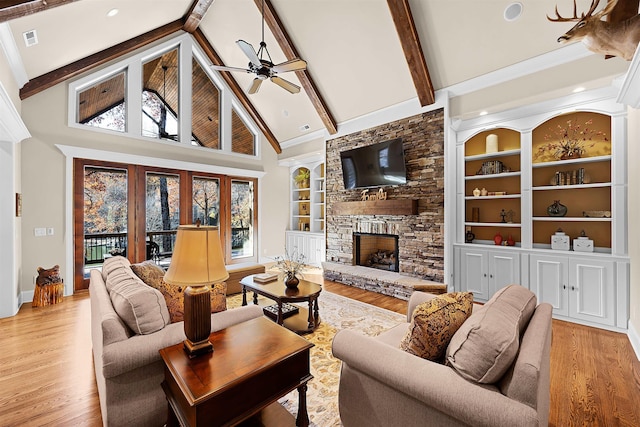 living room with beamed ceiling and plenty of natural light