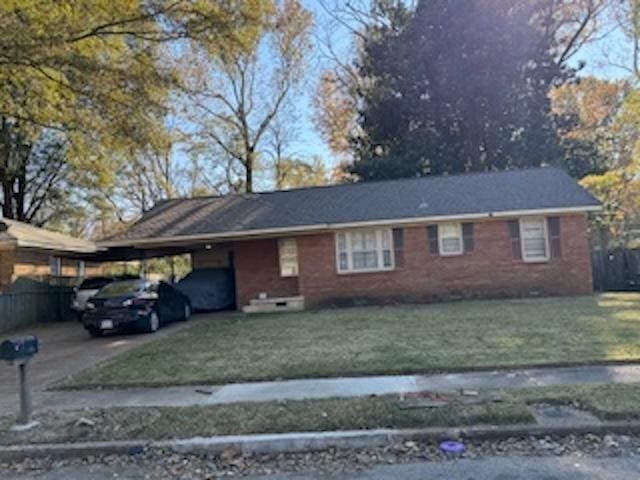 1675 Haywood Ave, Memphis, TN 38127 - ranch-style home featuring an attached carport, driveway, and brick siding