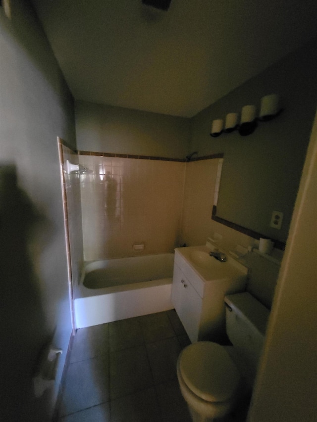 full bathroom featuring tile patterned flooring, vanity, toilet, and tiled shower / bath combo