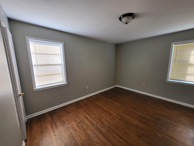 unfurnished room featuring dark hardwood / wood-style floors