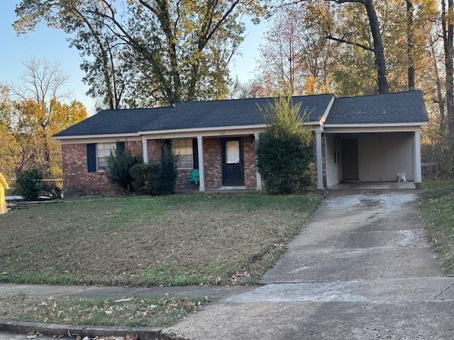 single story home with a carport and a front lawn