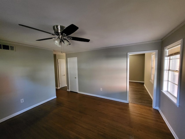 spare room with crown molding, dark hardwood / wood-style flooring, and ceiling fan