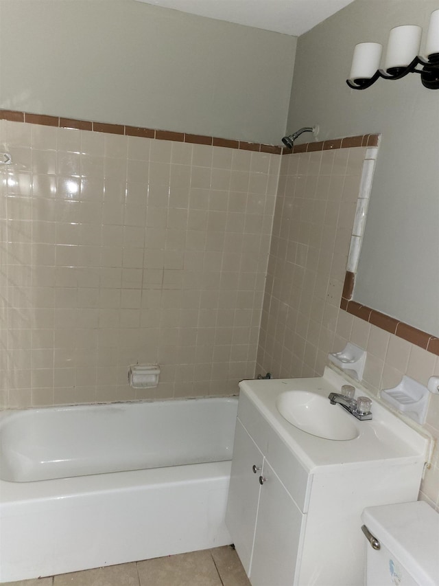 bathroom featuring tile patterned floors, vanity, and washtub / shower combination