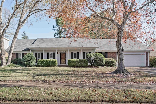 ranch-style house with a garage and a front lawn