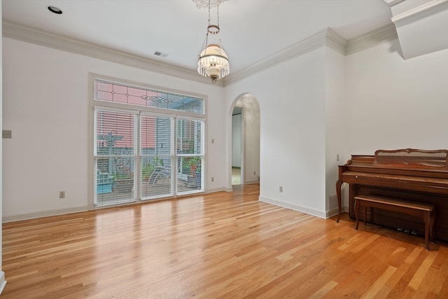 interior space with crown molding, light hardwood / wood-style flooring, and a chandelier