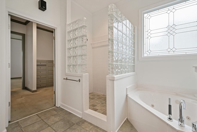 bathroom featuring tile patterned floors and separate shower and tub