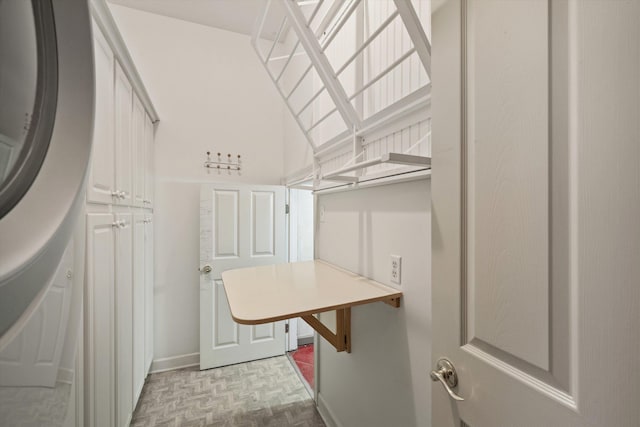 spacious closet featuring light parquet floors and washer / dryer