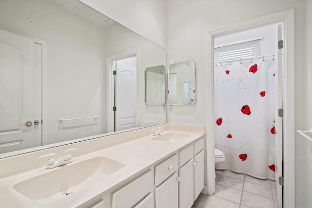 bathroom with toilet, vanity, tile patterned floors, and curtained shower