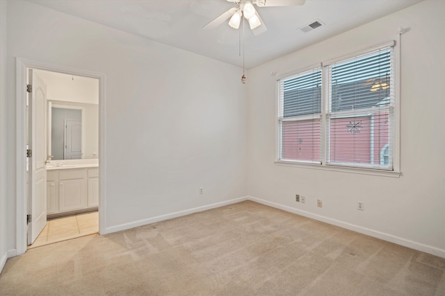 unfurnished room with light carpet and ceiling fan