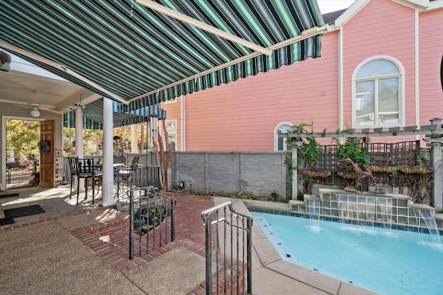 view of swimming pool featuring pool water feature, ceiling fan, and a patio