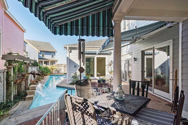 deck with a fenced in pool and pool water feature