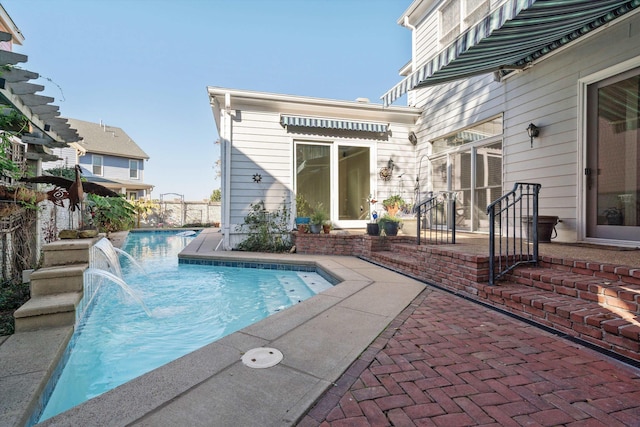 view of swimming pool featuring pool water feature and a patio area