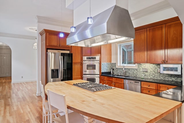 kitchen with stainless steel appliances, hanging light fixtures, light hardwood / wood-style flooring, backsplash, and island range hood