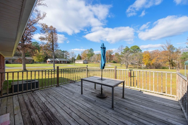 wooden deck featuring a yard