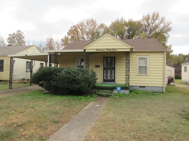 bungalow-style home featuring a carport and a front yard