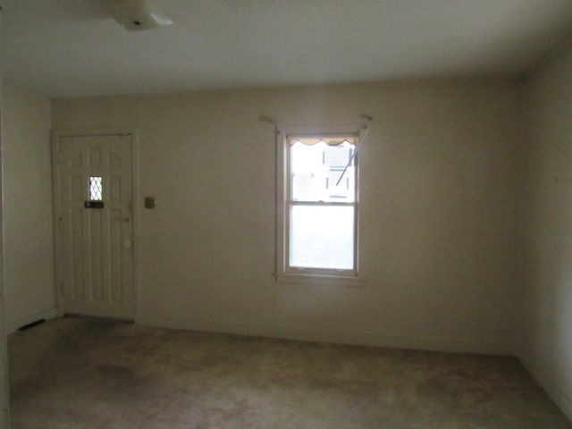 foyer featuring light carpet