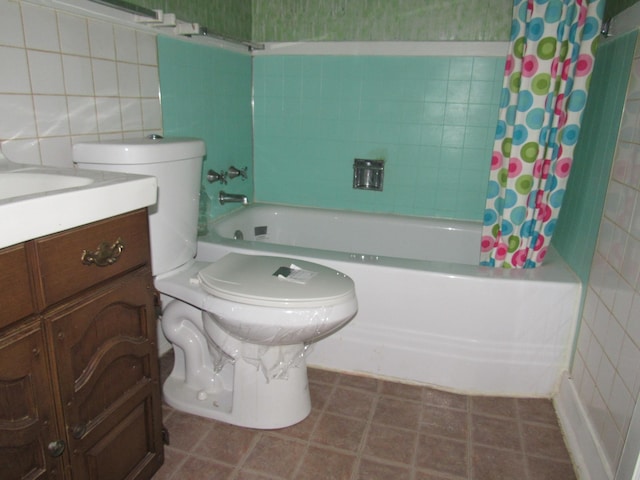 full bathroom with vanity, toilet, tile walls, and shower / bath combo with shower curtain