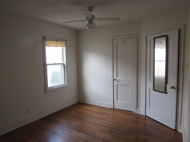 interior space with ceiling fan and dark wood-type flooring