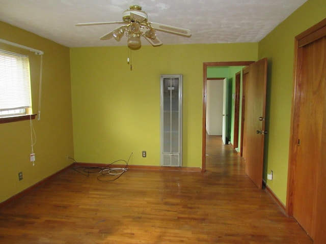 unfurnished room with hardwood / wood-style flooring and ceiling fan