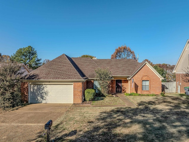 single story home featuring a garage and a front lawn