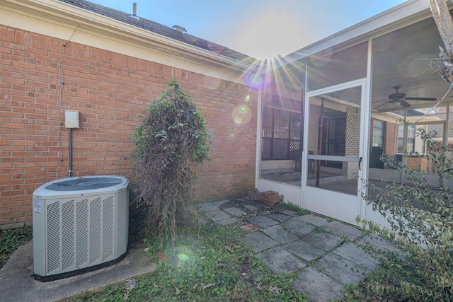 view of home's exterior with a sunroom, ceiling fan, and central air condition unit