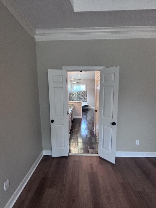 interior space featuring crown molding and dark wood-type flooring