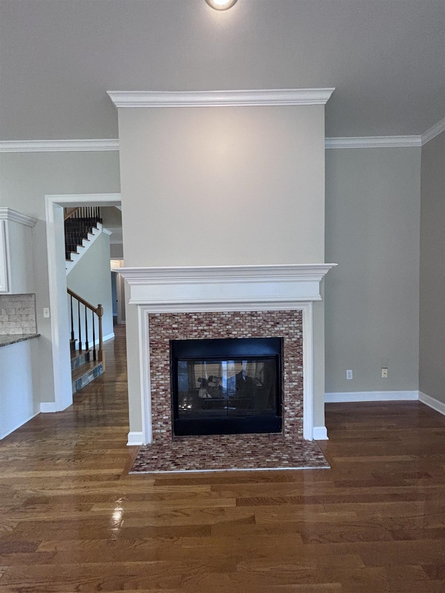 interior details with hardwood / wood-style floors, backsplash, crown molding, and a tiled fireplace