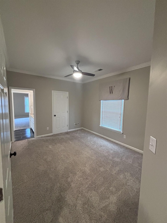 carpeted empty room featuring ceiling fan and ornamental molding