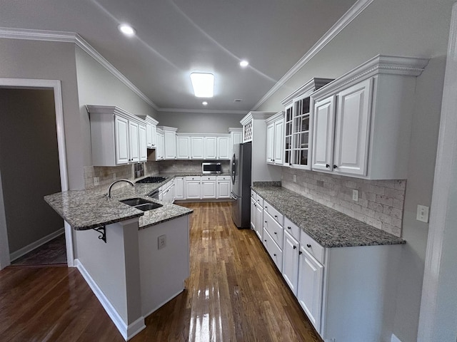 kitchen featuring appliances with stainless steel finishes, dark hardwood / wood-style flooring, ornamental molding, sink, and white cabinetry