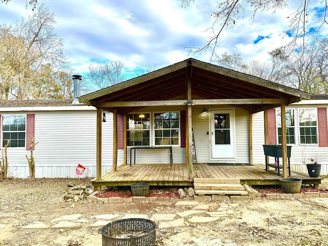 back of property with covered porch