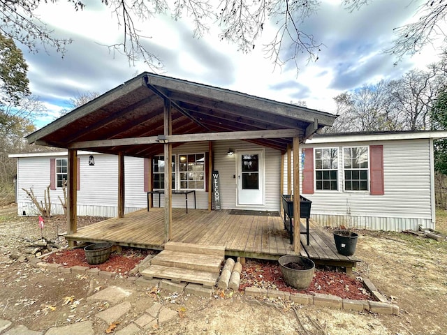 back of property featuring a deck