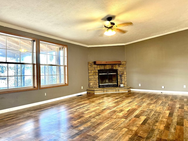 unfurnished living room with crown molding, wood-type flooring, a textured ceiling, and a fireplace