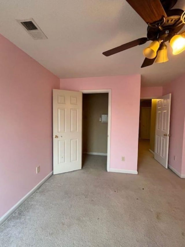 unfurnished bedroom featuring ceiling fan and light colored carpet