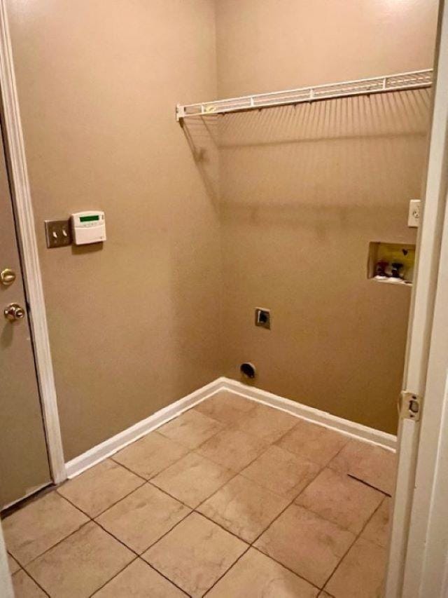 laundry area with hookup for an electric dryer, tile patterned floors, and hookup for a washing machine