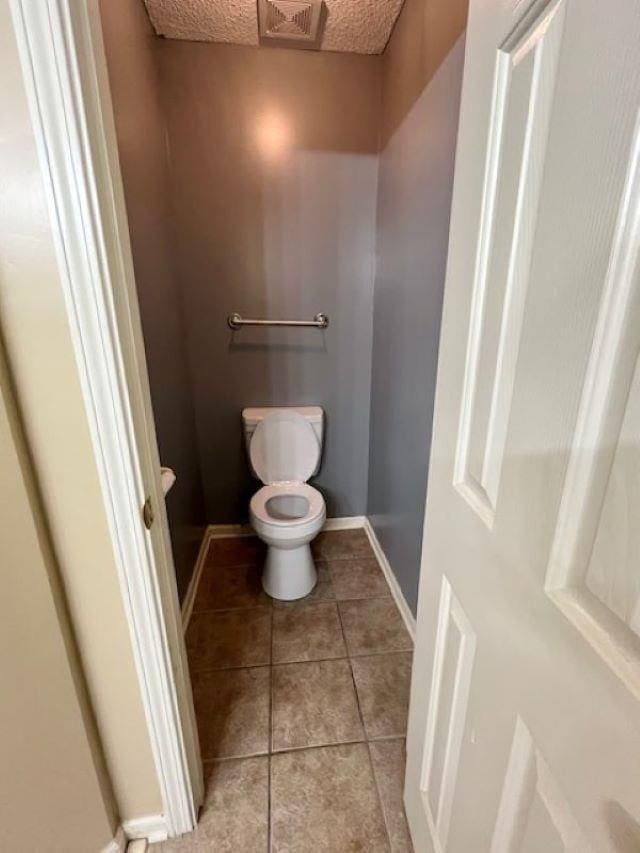 bathroom with tile patterned floors and toilet