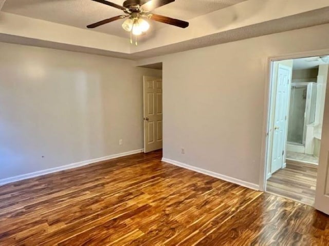 unfurnished room featuring dark hardwood / wood-style floors and ceiling fan