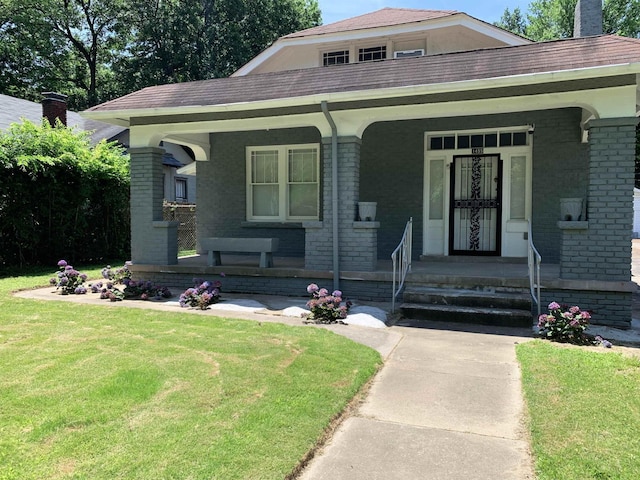 view of front of home featuring a porch and a front lawn