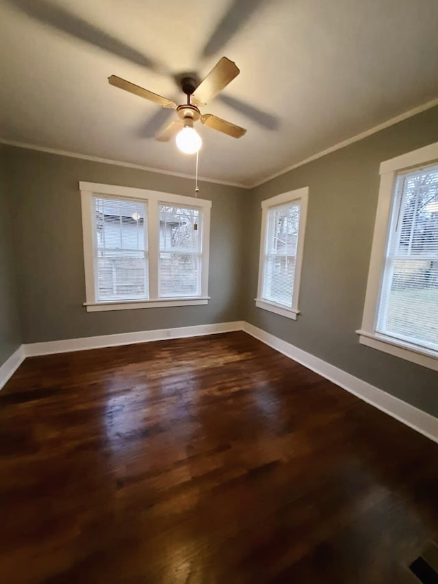 unfurnished room with dark hardwood / wood-style flooring, a healthy amount of sunlight, and ornamental molding