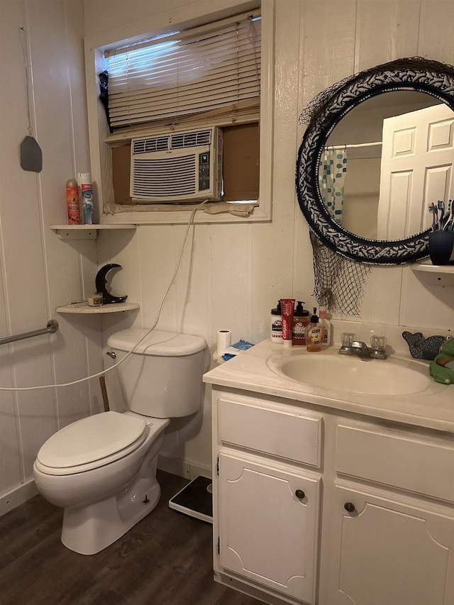 bathroom with hardwood / wood-style floors, vanity, and toilet