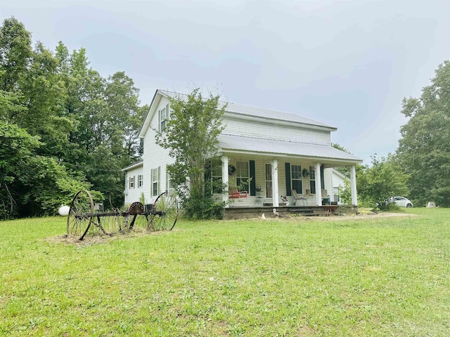 view of front of house featuring covered porch and a front lawn