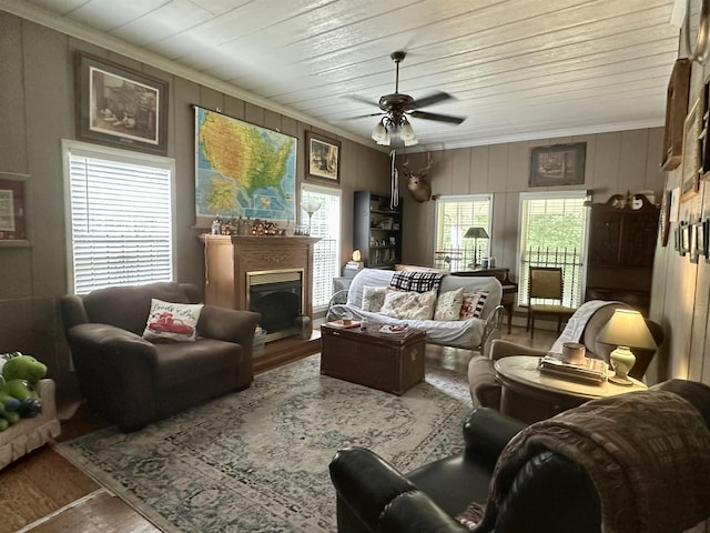 living room featuring hardwood / wood-style flooring, ceiling fan, crown molding, and wood ceiling