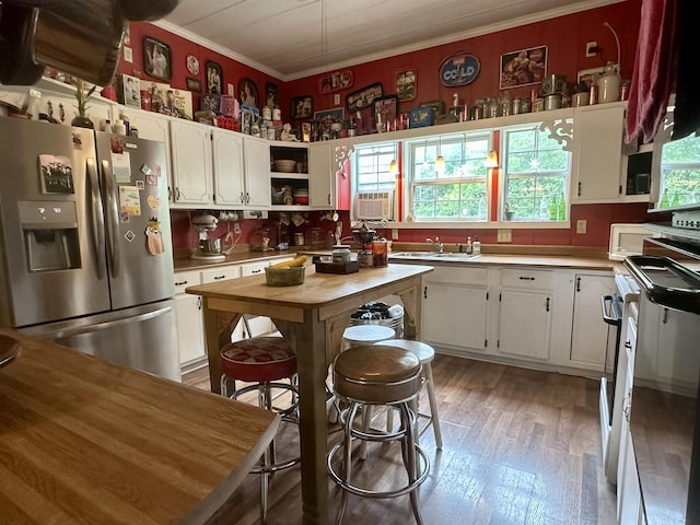 kitchen featuring white cabinets, white appliances, and light hardwood / wood-style flooring